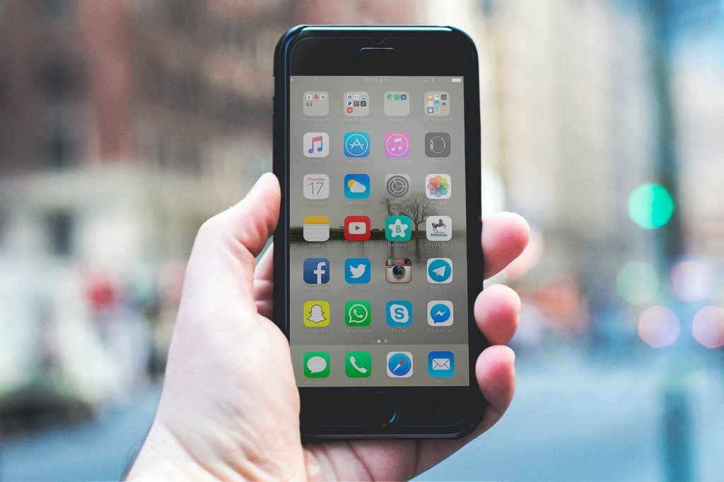person holding a space gray iPhone 6 and black case